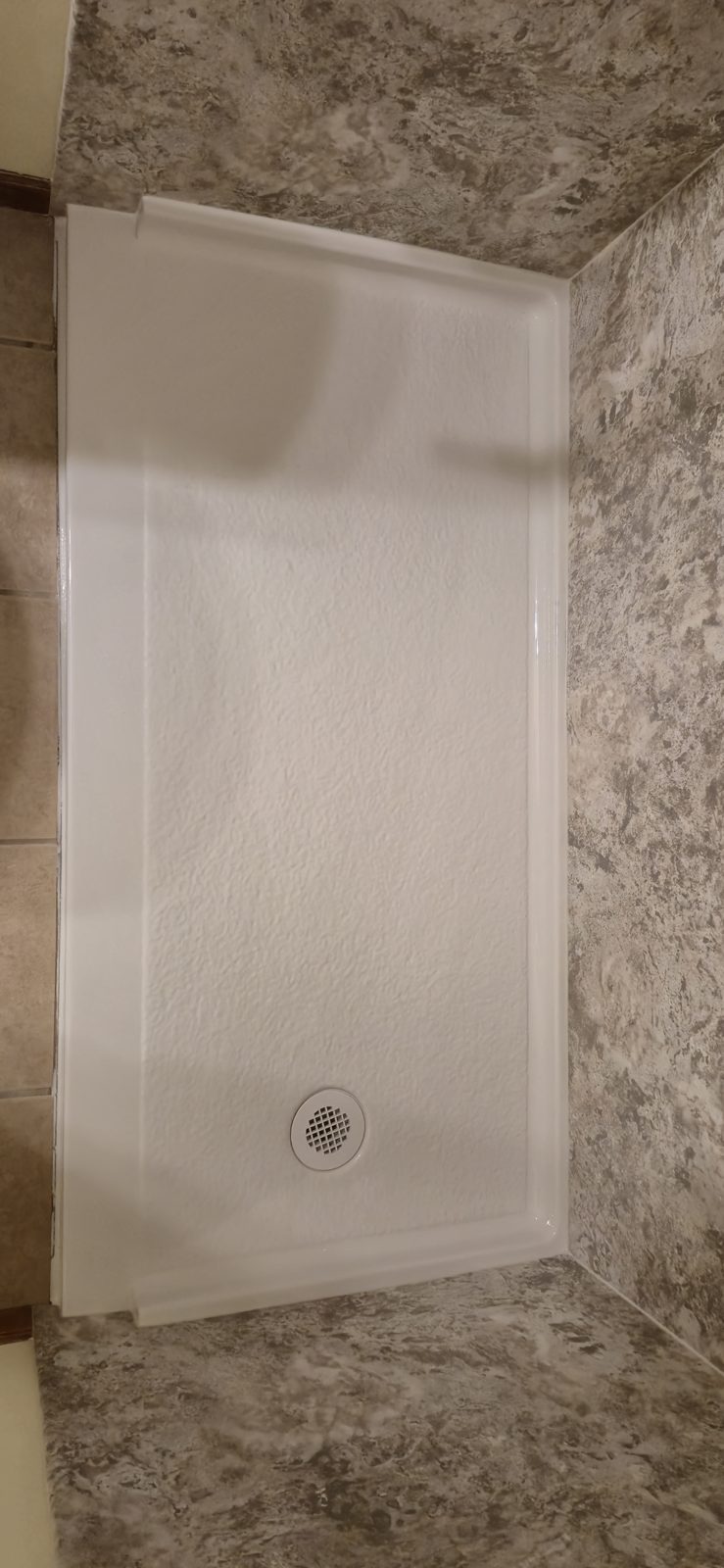 Low, flush-set shower pan in an accessibility-focused bathroom