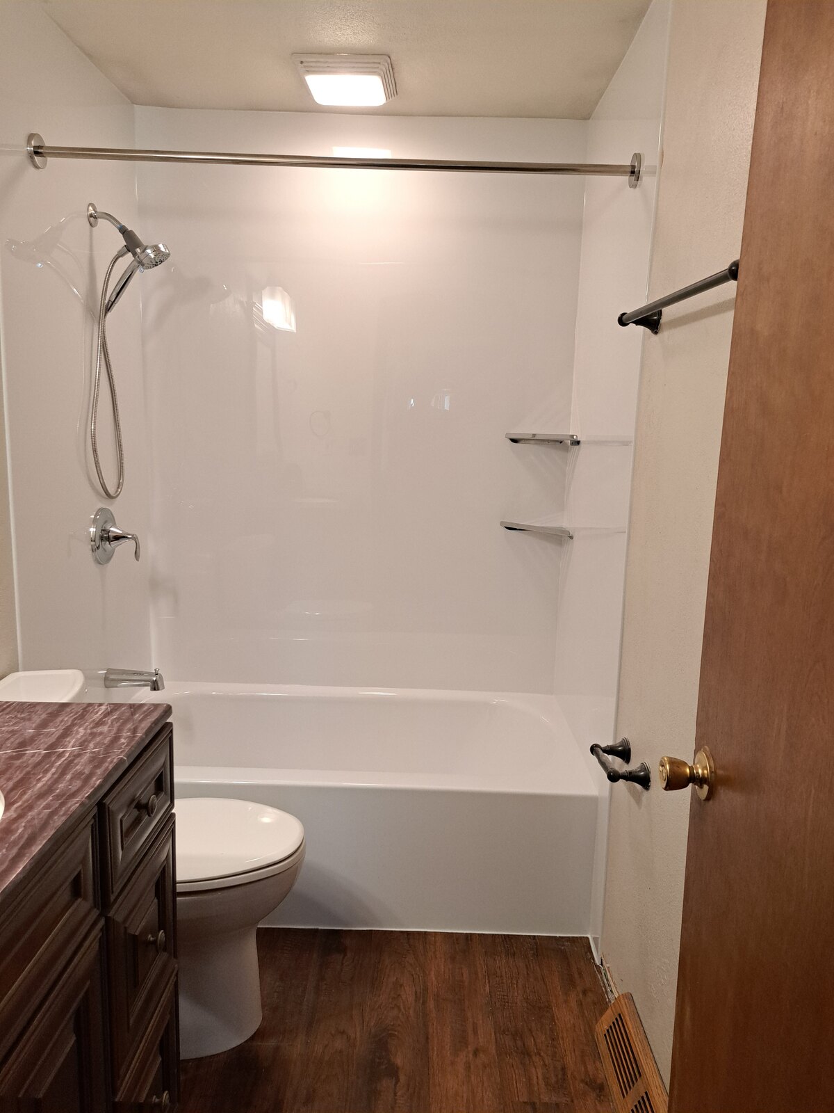 Finished replacement bathtub with white wall surround