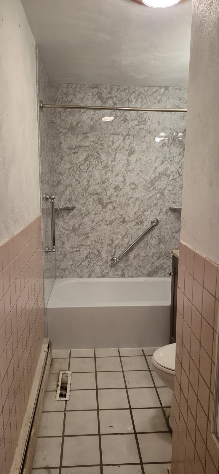 Finished replacement bathtub with marble-look surround