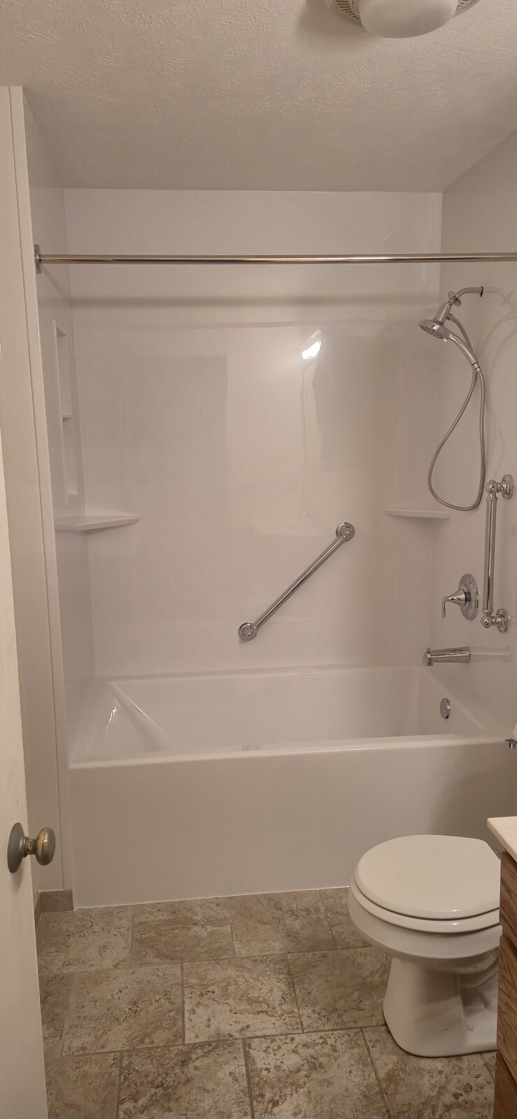 Finished replacement bathtub with smooth white acrylic surround