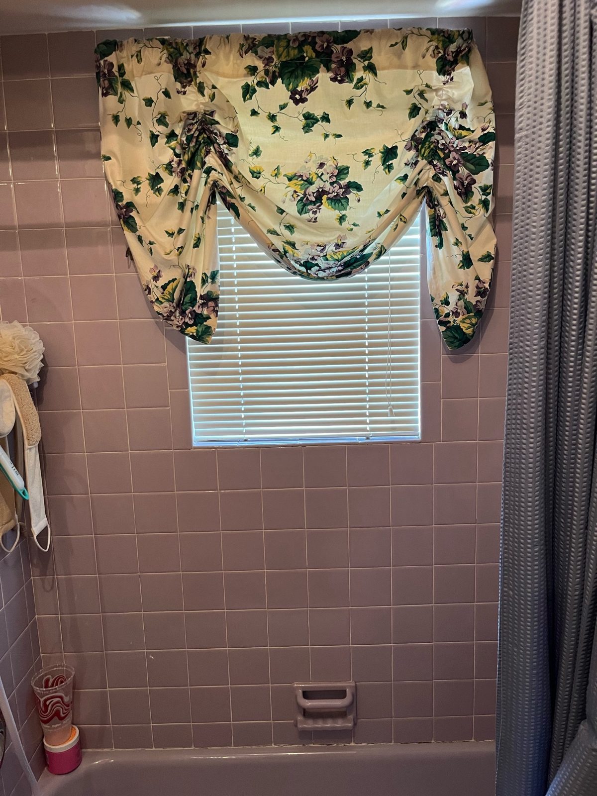 Original lavender-tile bathroom before the cast-iron tub was removed