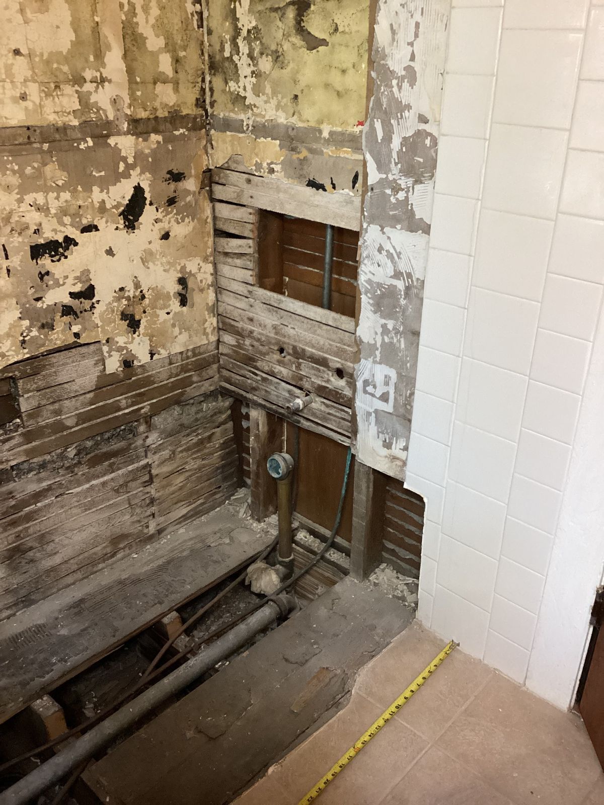 Bathroom wall framing exposed during remodeling