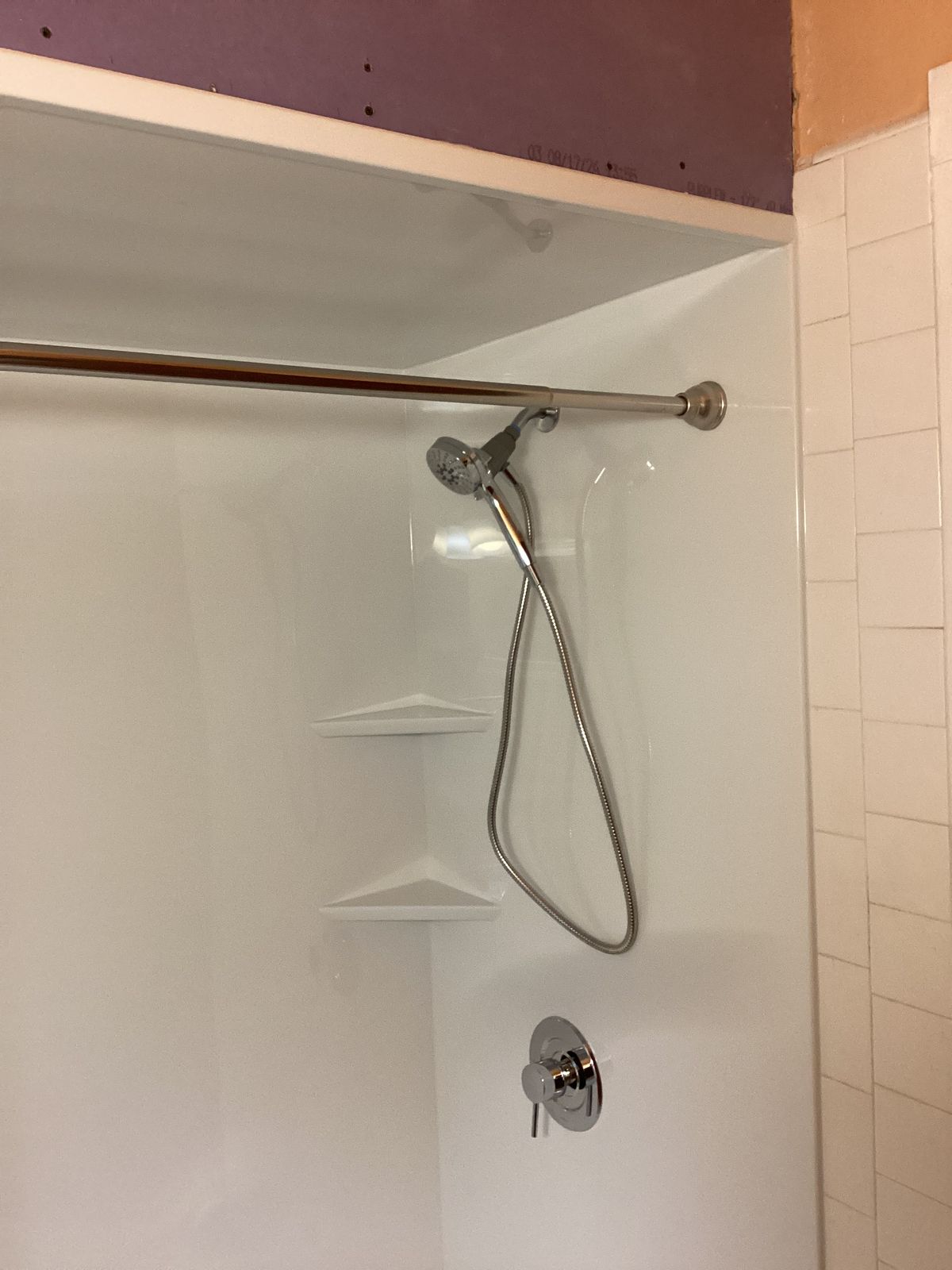 Finished shower header showing shower rod and fixtures