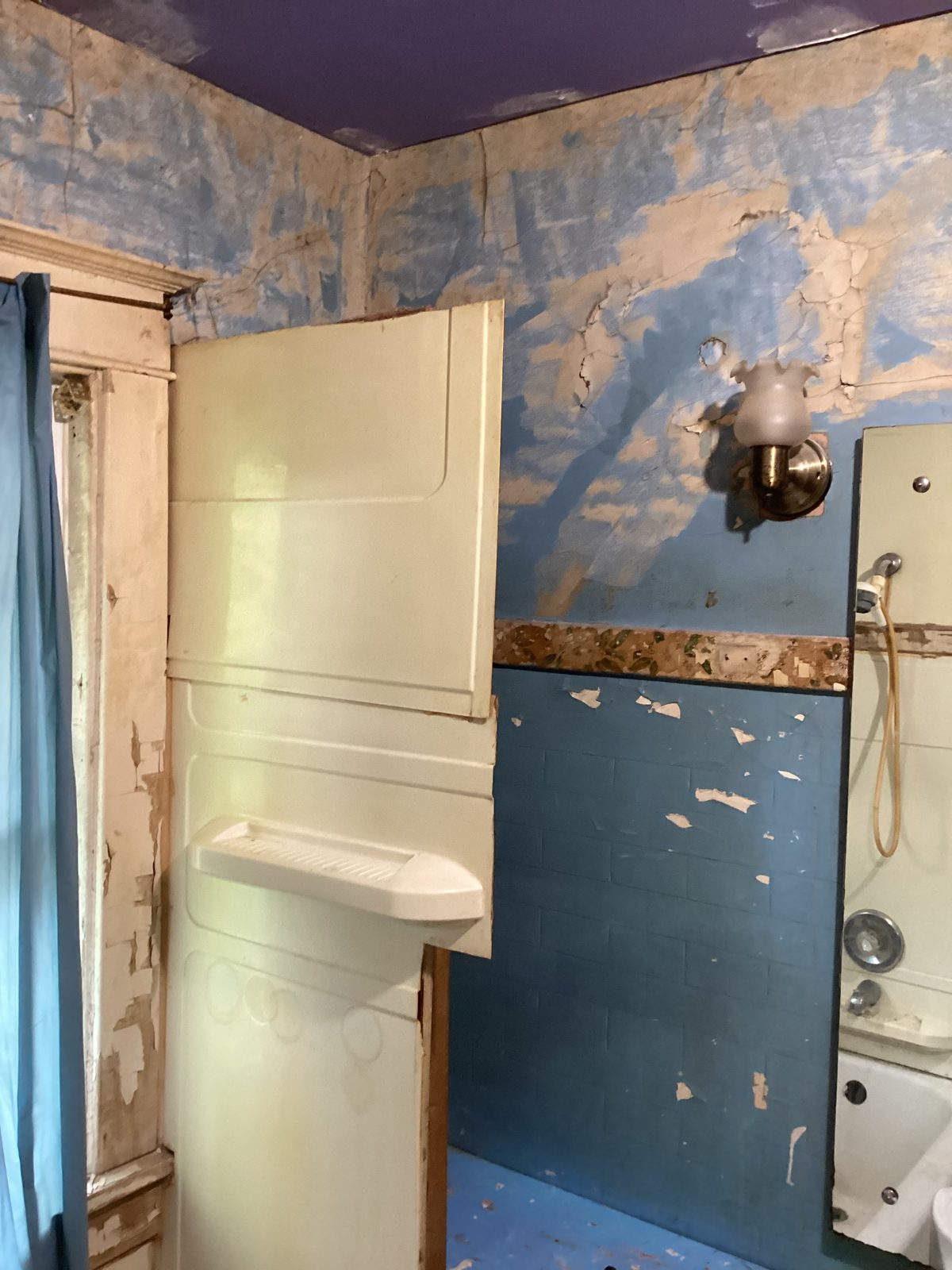 Old tub surround panels pulled away at the start of tear-out
