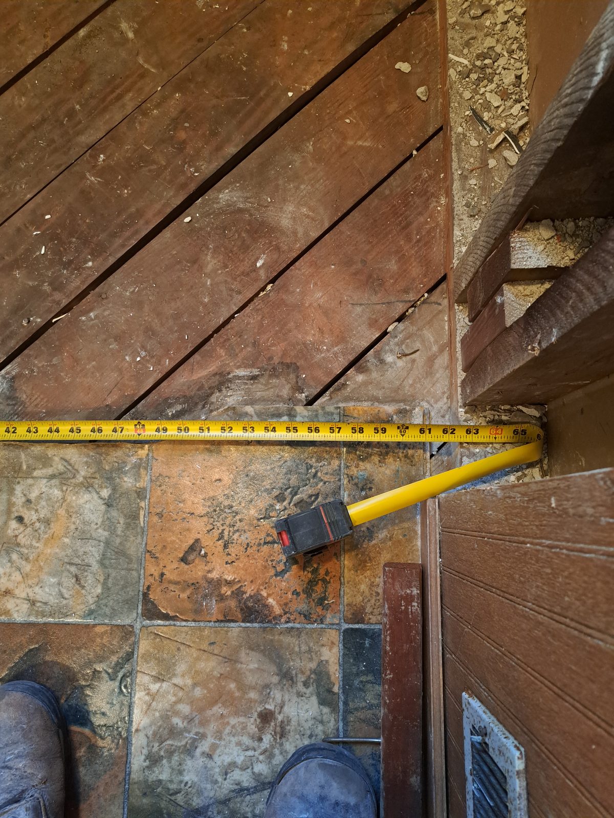 Measuring the wood subfloor where the old tub sat