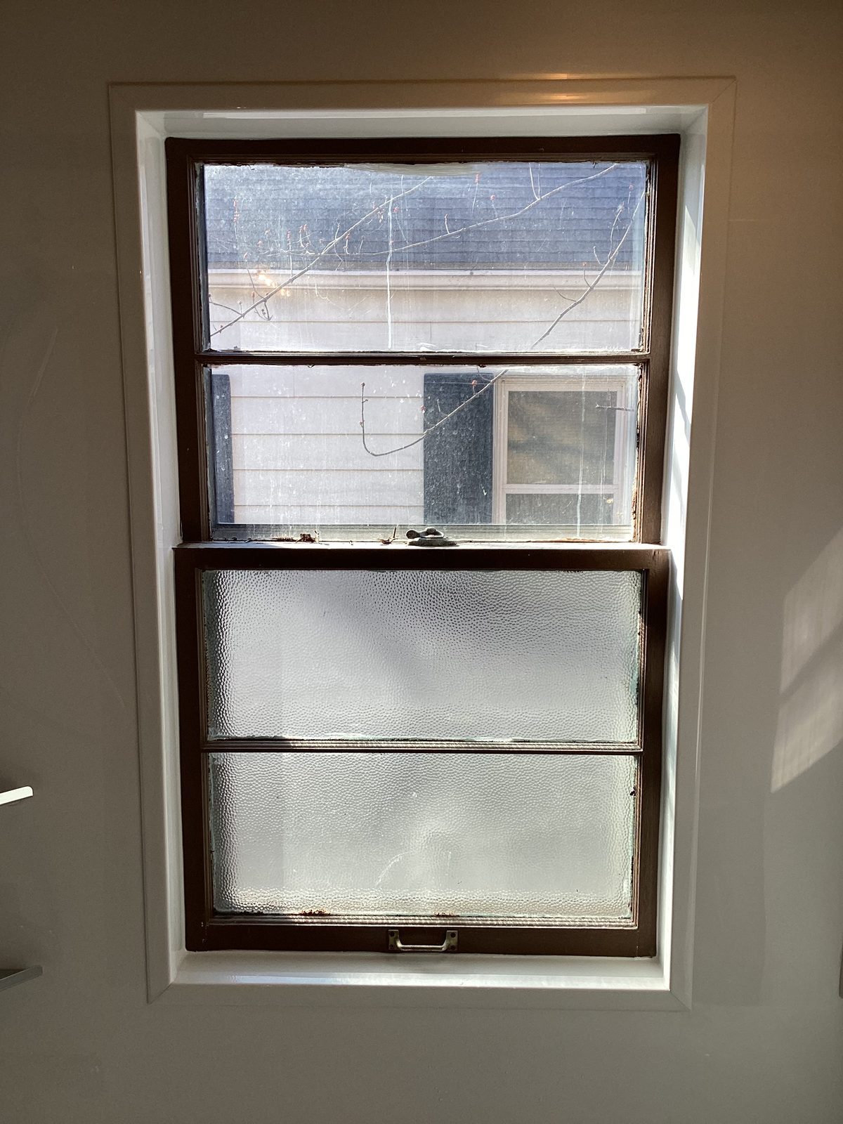 Wall surround trimmed around a wood double-hung window