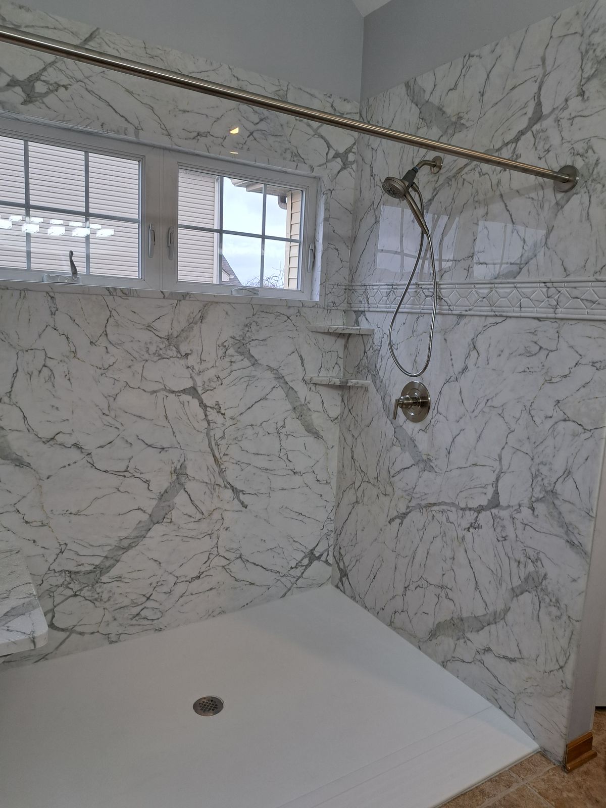 Finished marble-look shower ceiling and walls with fixtures