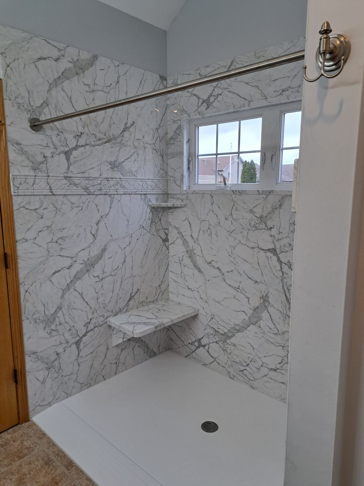 Finished marble-look shower wall with window