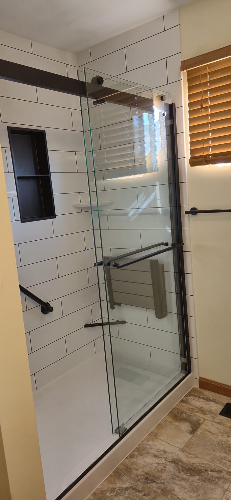 Finished subway tile shower with sliding glass door