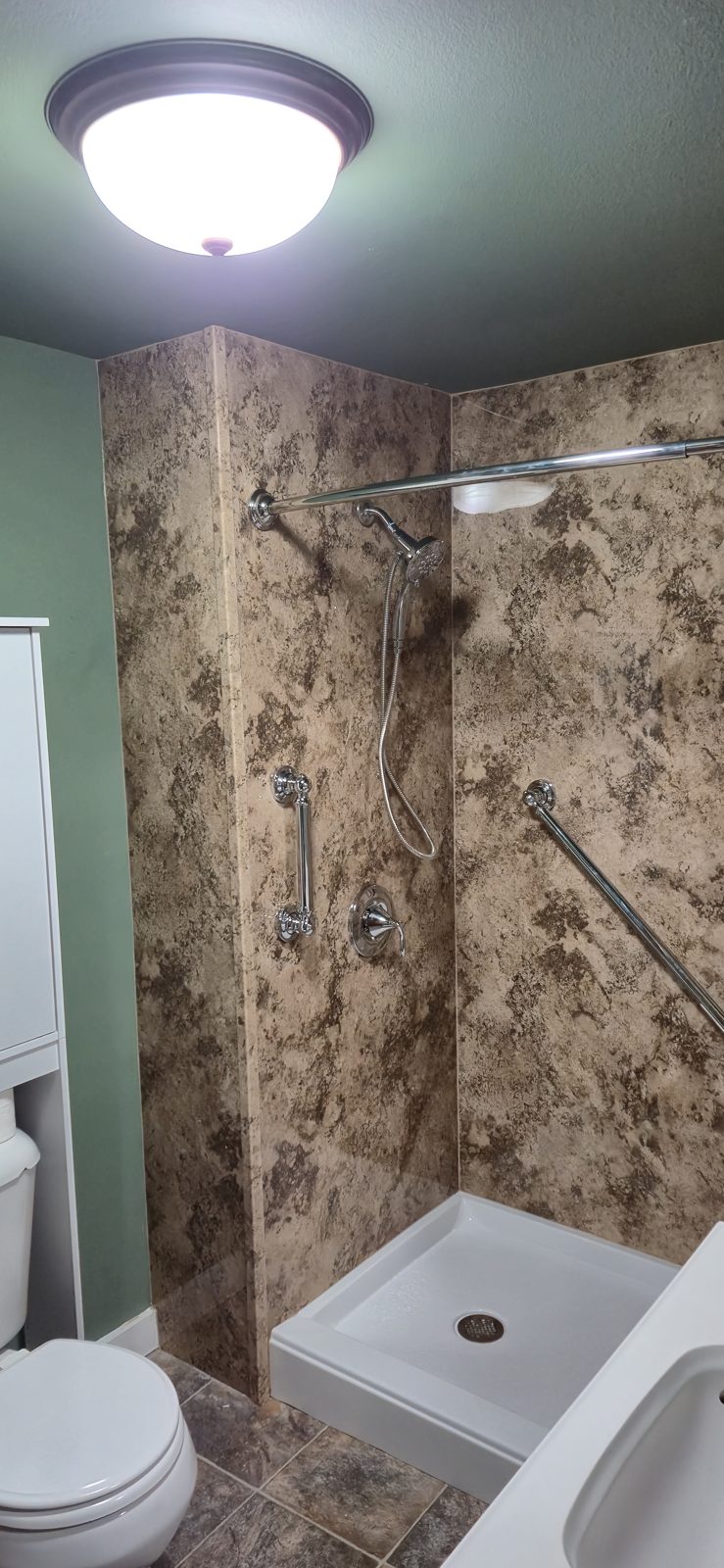 Marble-look walk-in shower with two grab bars and a low-entry pan